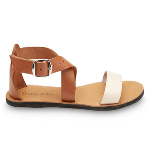 Side view of Brave Soles Sustainably made Jasmine leather sandals with recycled tire soles in ivory and caramel color