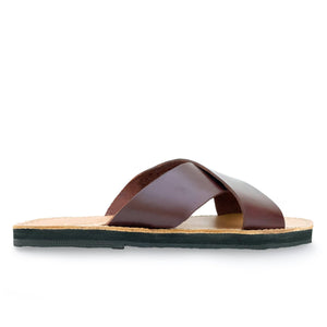lower side view of the Brave Soles Constanza leather slide sandal that is sustainably made and has upcycled tire soles. Pictured in root beer and natural color.