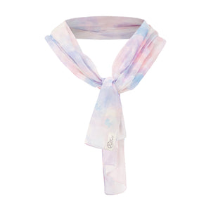 this is willow sustainable long scarf in GOTS cotton, in the unique tie dye print in pink. This is a ghost photo of the scarf drapped around a neck,knotted in front