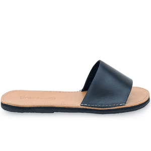 Side view of The Linda Women's Leather Slide Sandal in black and natural color, sustainably made by Brave Soles.