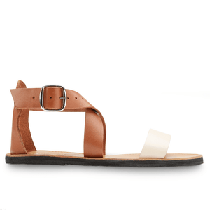 Lower side view of Brave Soles Sustainably made Jasmine leather sandals with recycled tire soles in ivory and caramel color