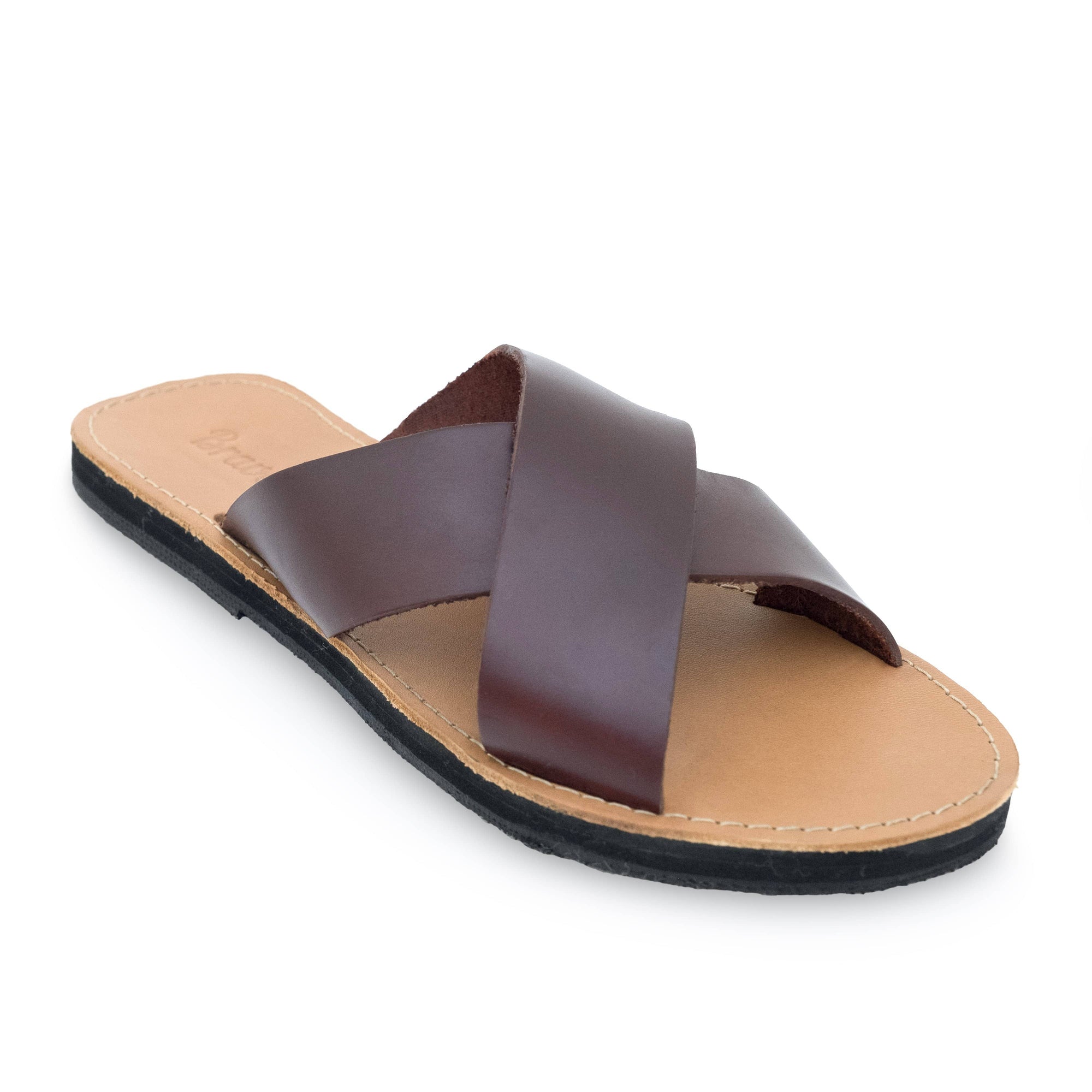 Front side view of the Brave Soles Constanza leather slide sandal that is sustainably made and has upcycled tire soles. Pictured in root beer and natural color.