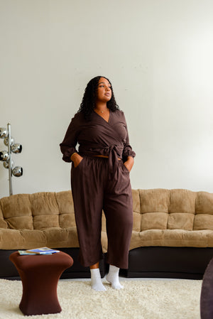 plus size black woman wearing a wide leg loose silky pant with a matching wrap top