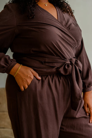 close up view on a silky dark brown set pants and wrap top combo